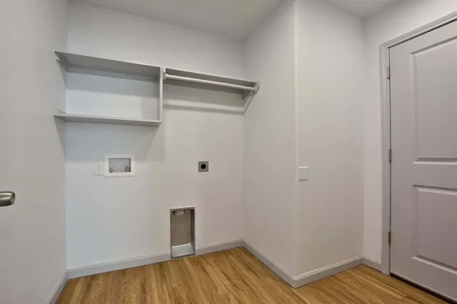 a view of a room with wooden floor and closet