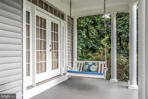 a view of a balcony with a table and chairs