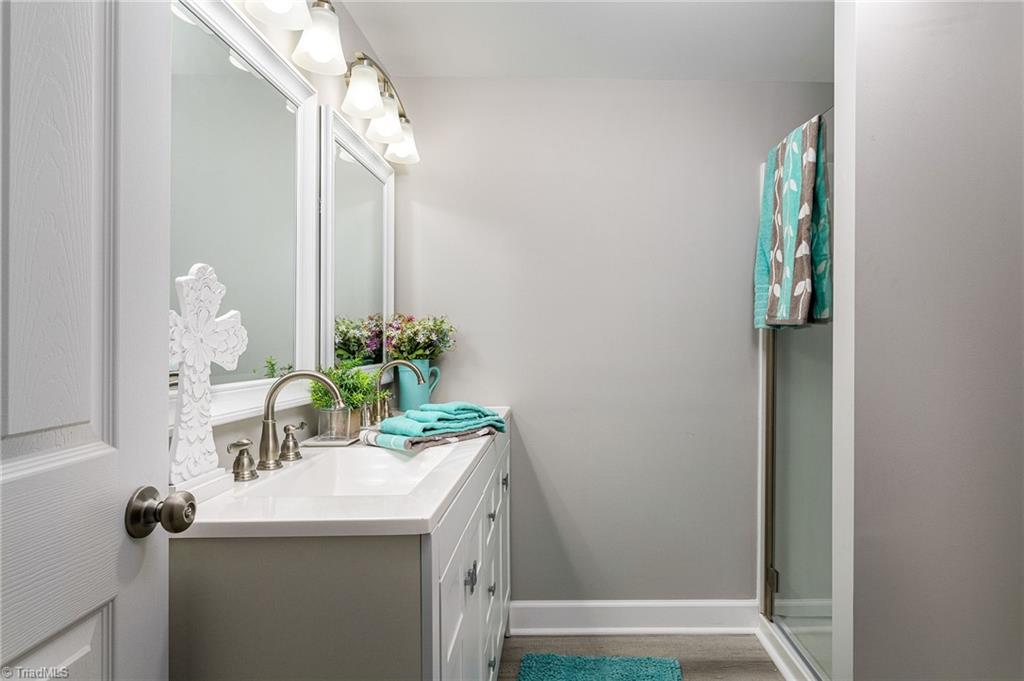 5515 Bethania Road Pfafftown, NC 27040 - Photo 29 of 49 New vanity, sinks, commode, walk in shower and lighting