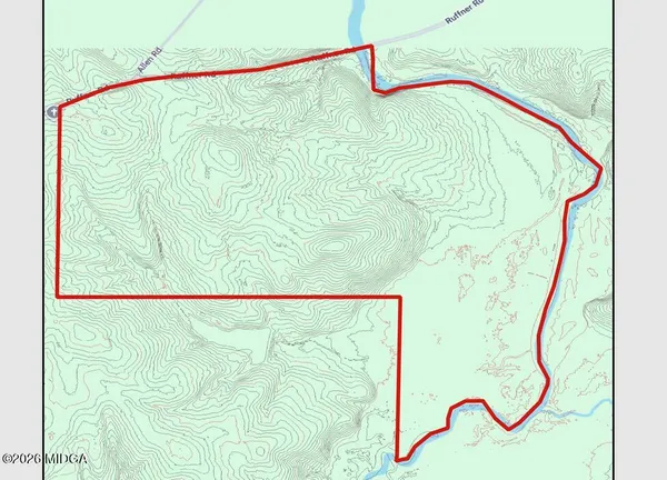 an aerial view of a residential houses with outdoor space and street view