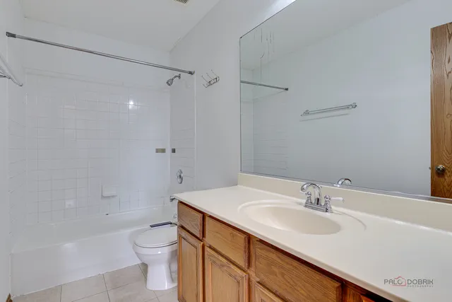 a bathroom with a sink toilet vanity and shower
