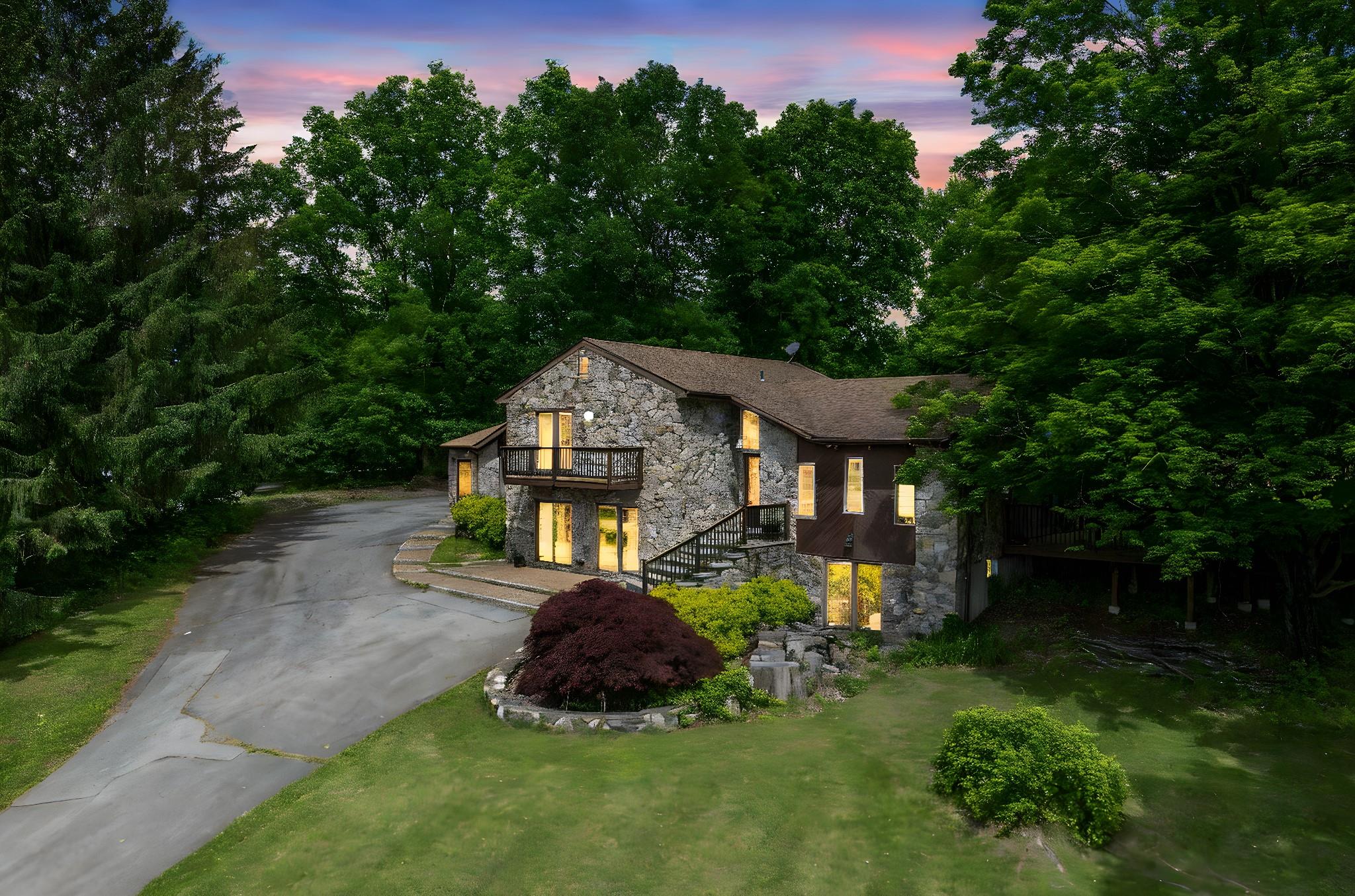 23 Fox Road Florida, NY 10921 - Photo 1 of 1 Contemporary home with stone siding, a balcony, asphalt driveway, and a front yard