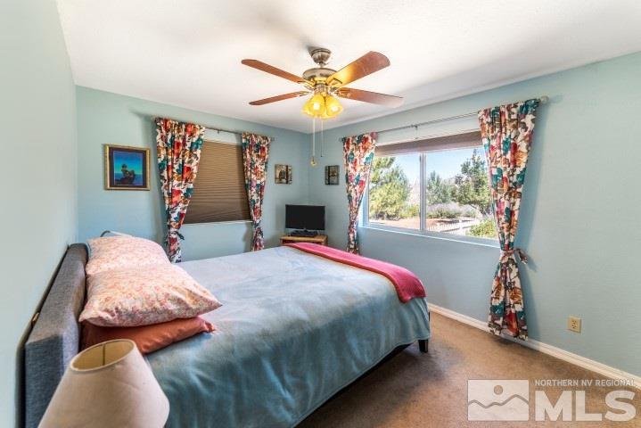 5155 Pasture View Road Reno, NV 89510 - Photo 16 of 21 a bedroom with a bed and a chandelier