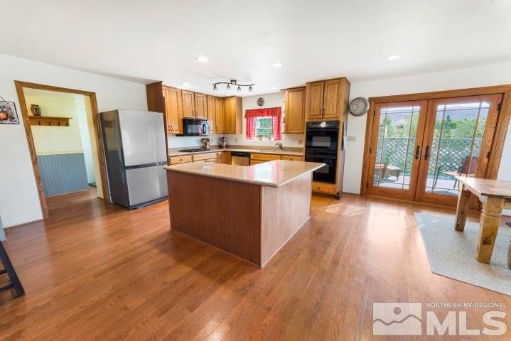 5155 Pasture View Road Reno, NV 89510 - Photo 5 of 21 a large kitchen with stainless steel appliances wooden floors and large window