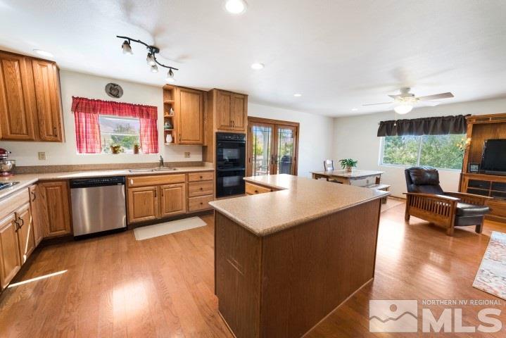 5155 Pasture View Road Reno, NV 89510 - Photo 7 of 21 a open kitchen with stainless steel appliances granite countertop a sink dishwasher a stove and a refrigerator with wooden floor