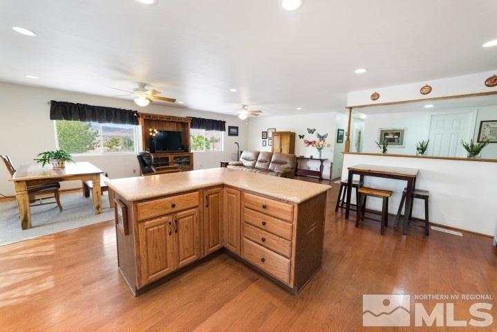 5155 Pasture View Road Reno, NV 89510 - Photo 8 of 21 a kitchen with stainless steel appliances kitchen island granite countertop a table chairs and a sink