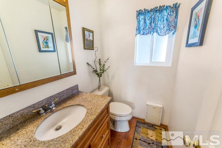 5155 Pasture View Road Reno, NV 89510 - Photo 9 of 21 a bathroom with a granite countertop sink mirror vanity and toilet