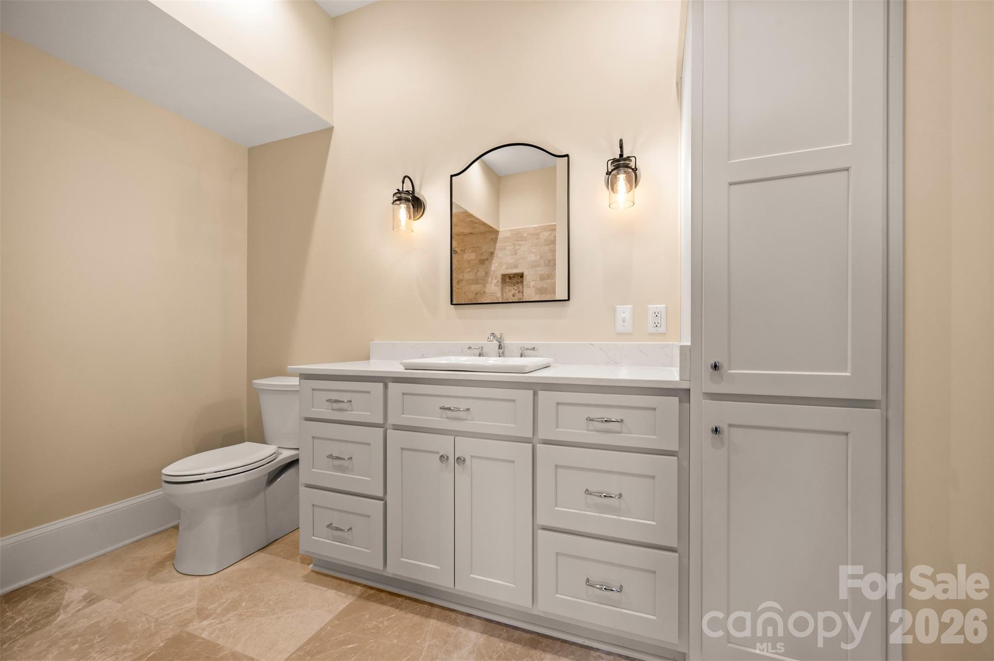 297 Mountain Meadows Lane, Unit 7 Tryon, NC 28782 - Photo 36 of 47 a bathroom with a toilet sink and mirror