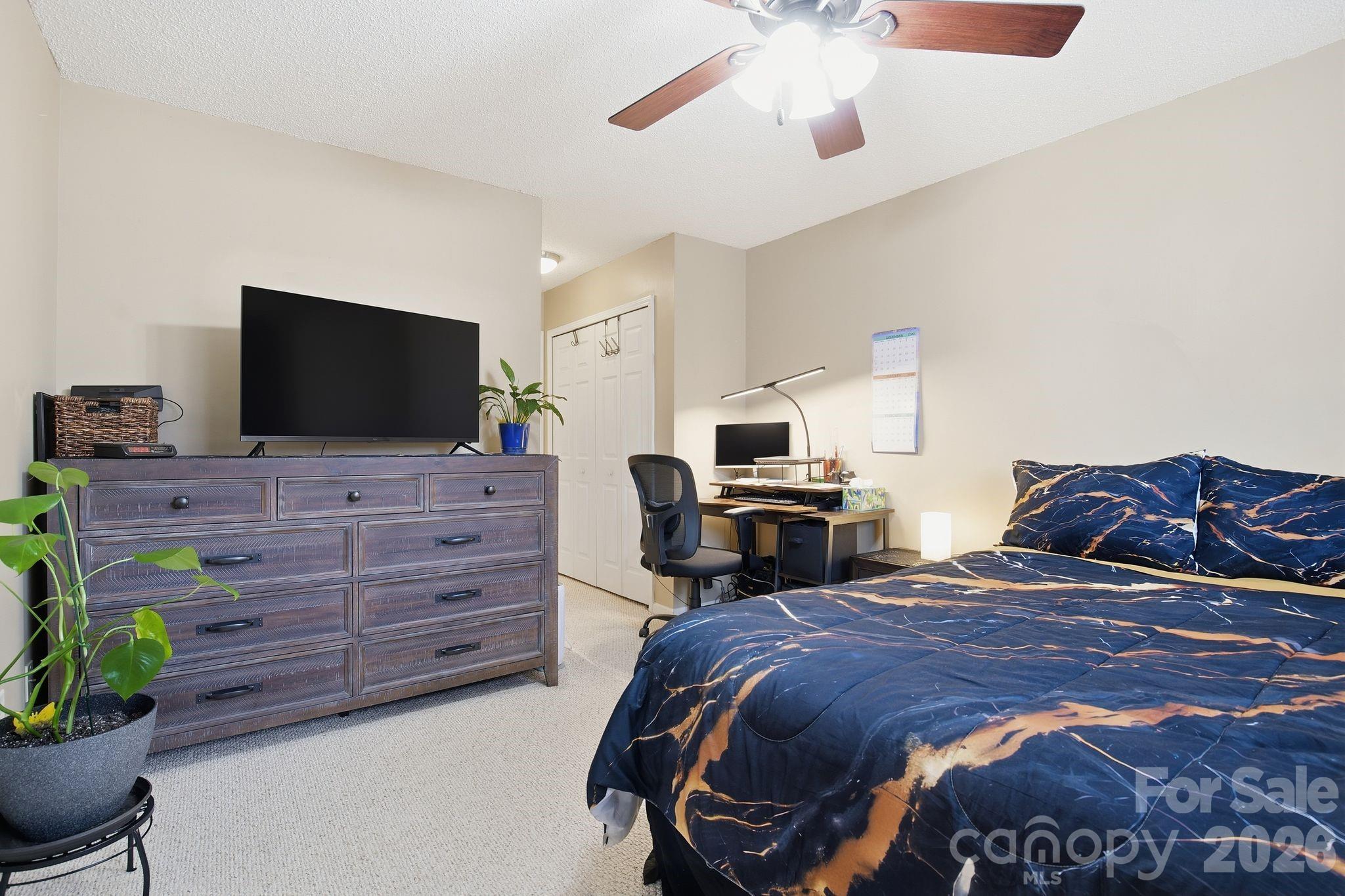 8376 Rudolph Road Charlotte, NC 28216 - Photo 11 of 28 a bed room with a bed and a television