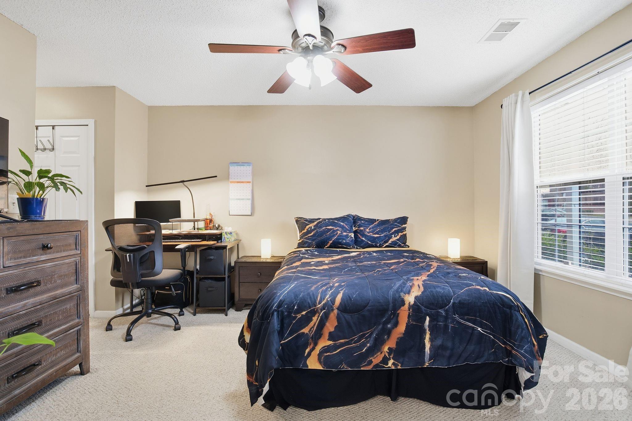 8376 Rudolph Road Charlotte, NC 28216 - Photo 12 of 28 a bedroom with a bed and a window