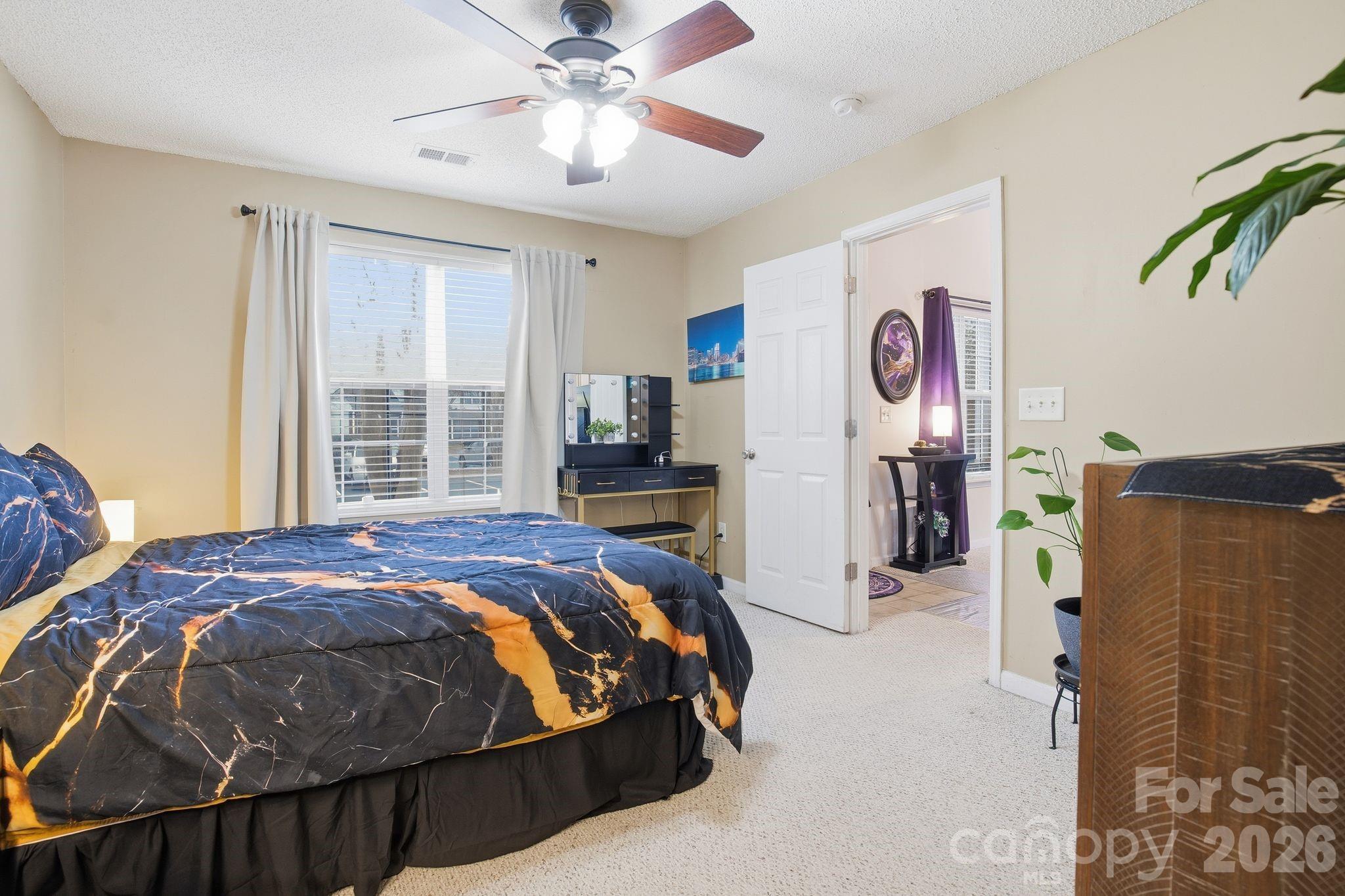 8376 Rudolph Road Charlotte, NC 28216 - Photo 13 of 28 a bed sitting in a bedroom next to a window