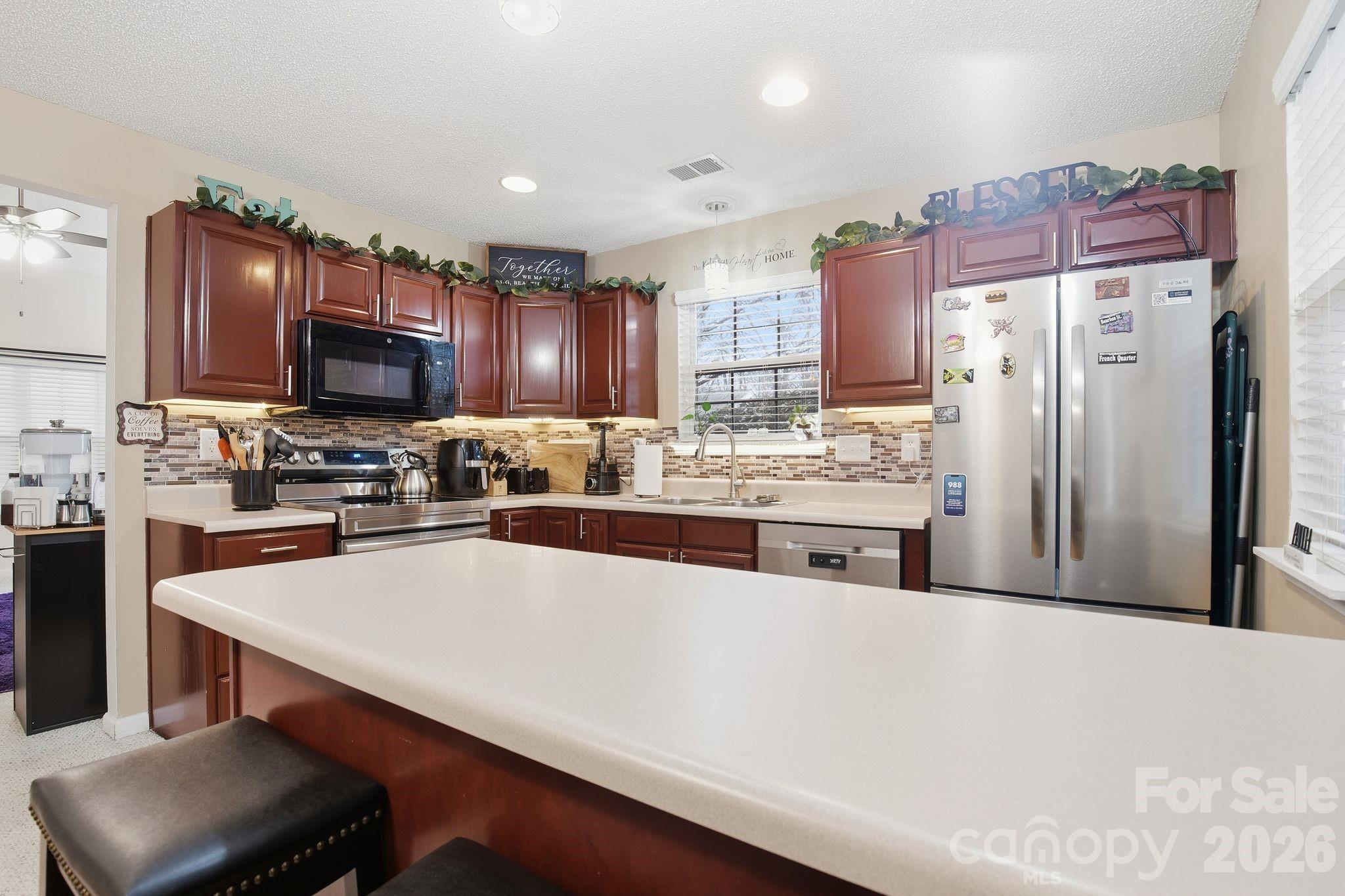 8376 Rudolph Road Charlotte, NC 28216 - Photo 17 of 28 a kitchen with stainless steel appliances a refrigerator sink and microwave