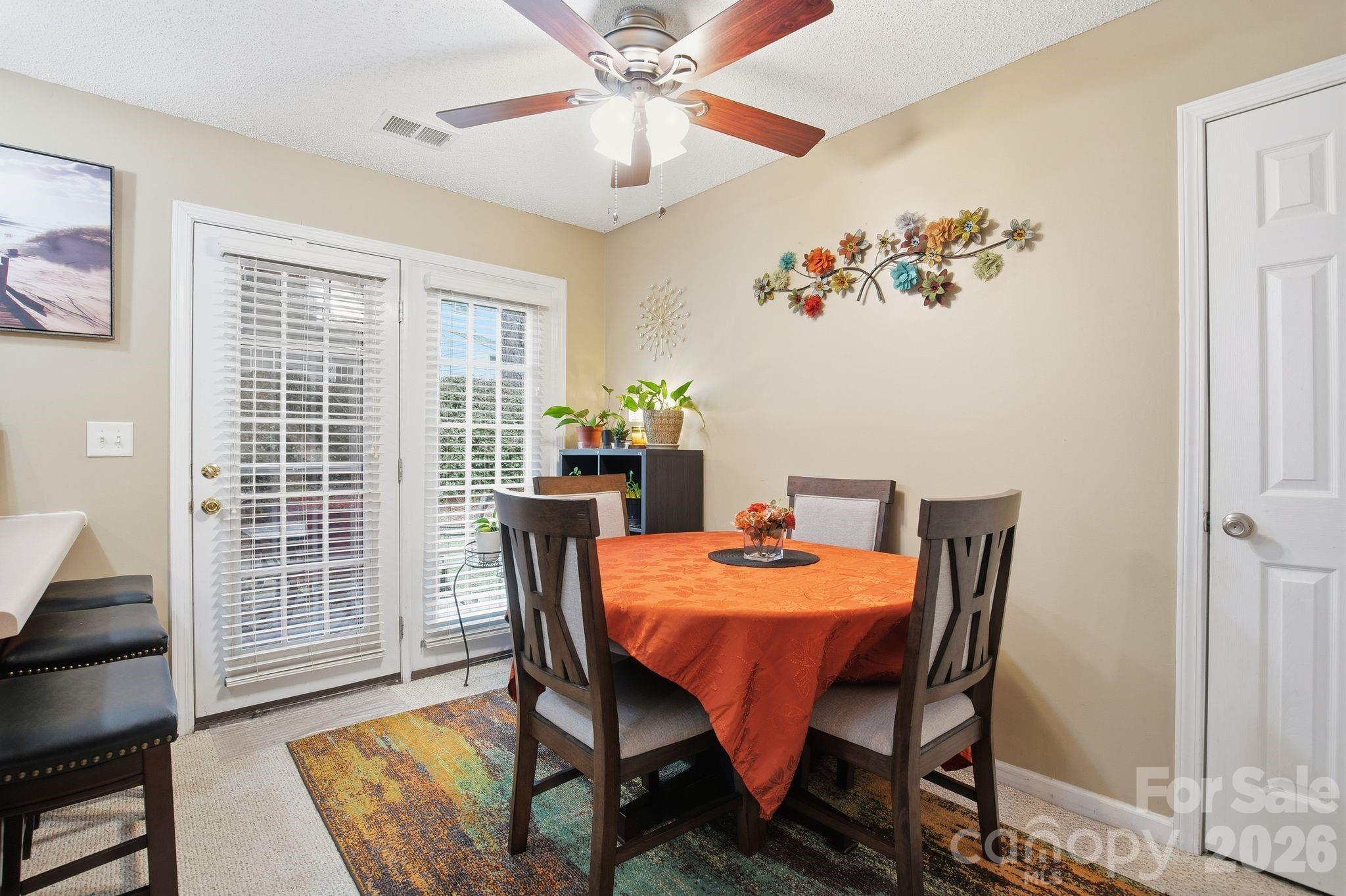 8376 Rudolph Road Charlotte, NC 28216 - Photo 18 of 28 a view of a dining room with furniture window and wooden floor