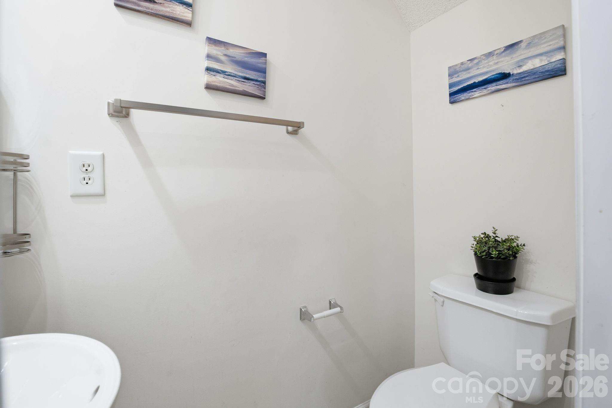 8376 Rudolph Road Charlotte, NC 28216 - Photo 19 of 28 a white toilet sitting next to a bathroom sink