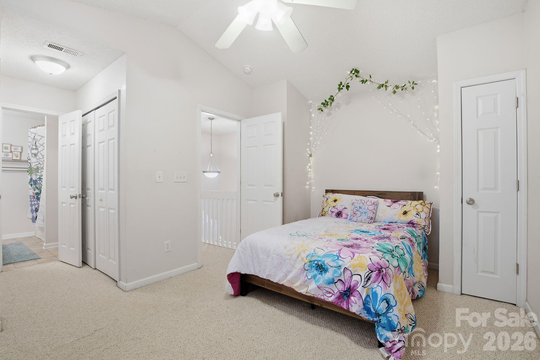 8376 Rudolph Road Charlotte, NC 28216 - Photo 21 of 28 a bedroom with a bed and a chandelier