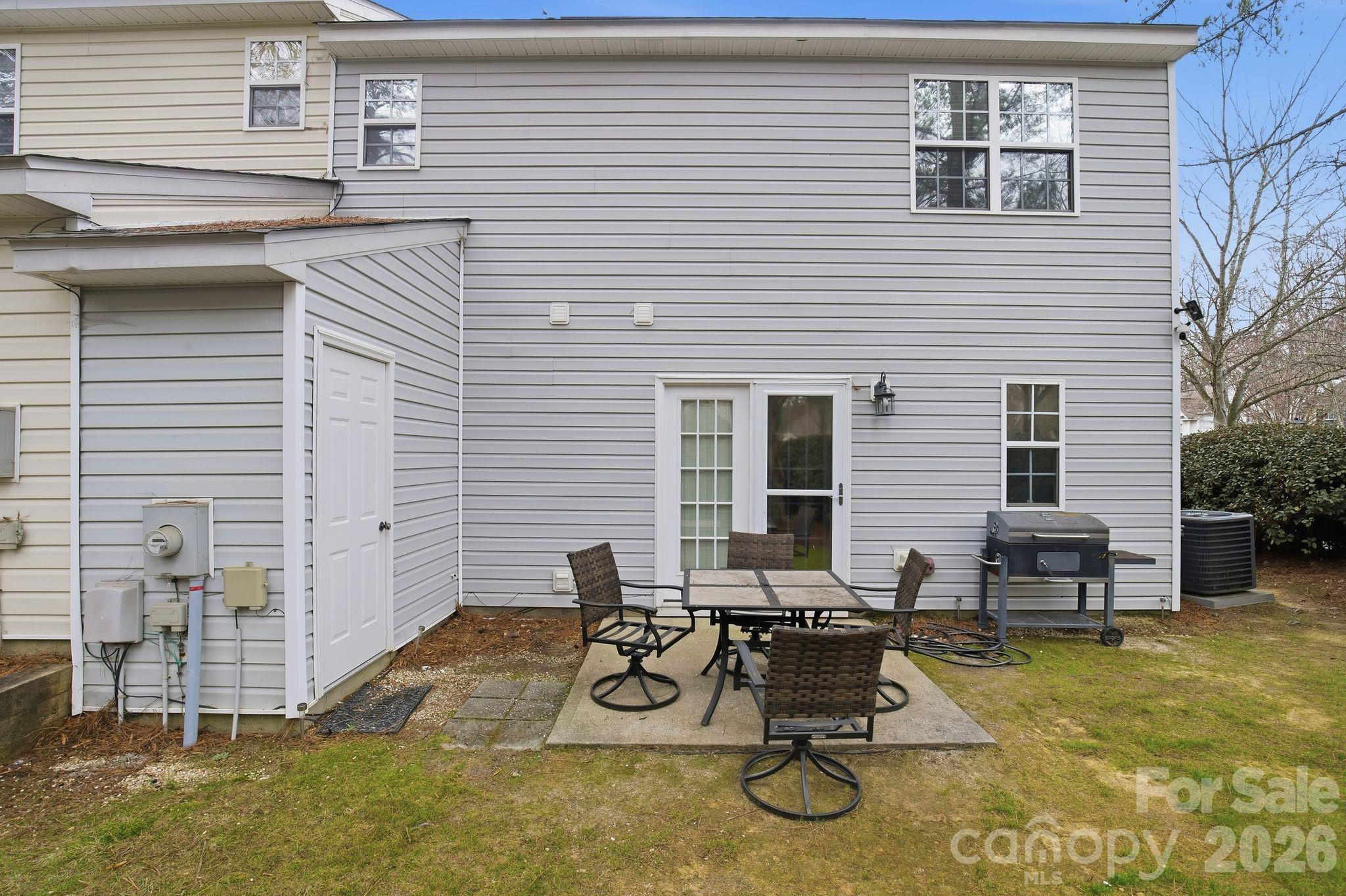 8376 Rudolph Road Charlotte, NC 28216 - Photo 6 of 28 a view of a patio with table and chairs with wooden floor