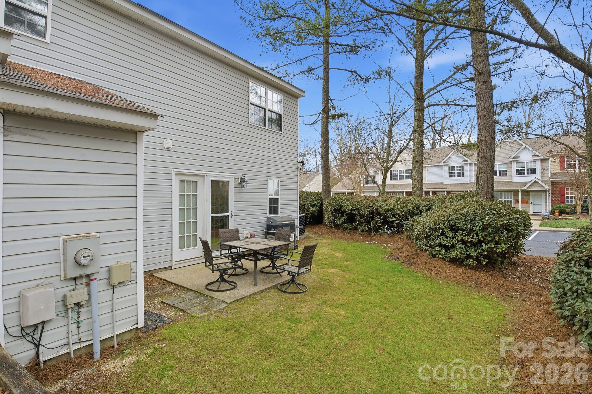 8376 Rudolph Road Charlotte, NC 28216 - Photo 7 of 28 a view of a patio with table and chairs and potted plants