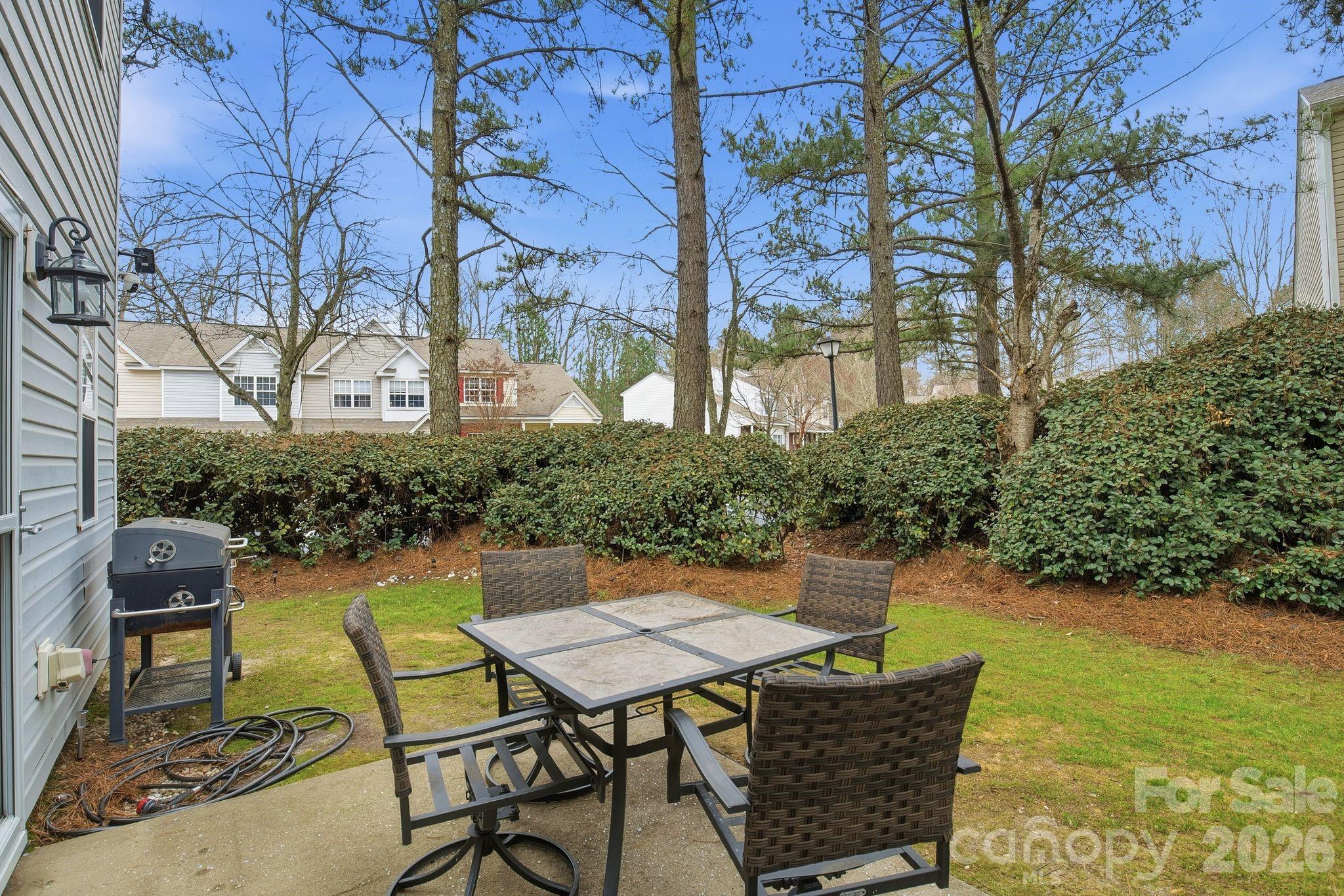 8376 Rudolph Road Charlotte, NC 28216 - Photo 8 of 28 a view of a patio with table and chairs and potted plants
