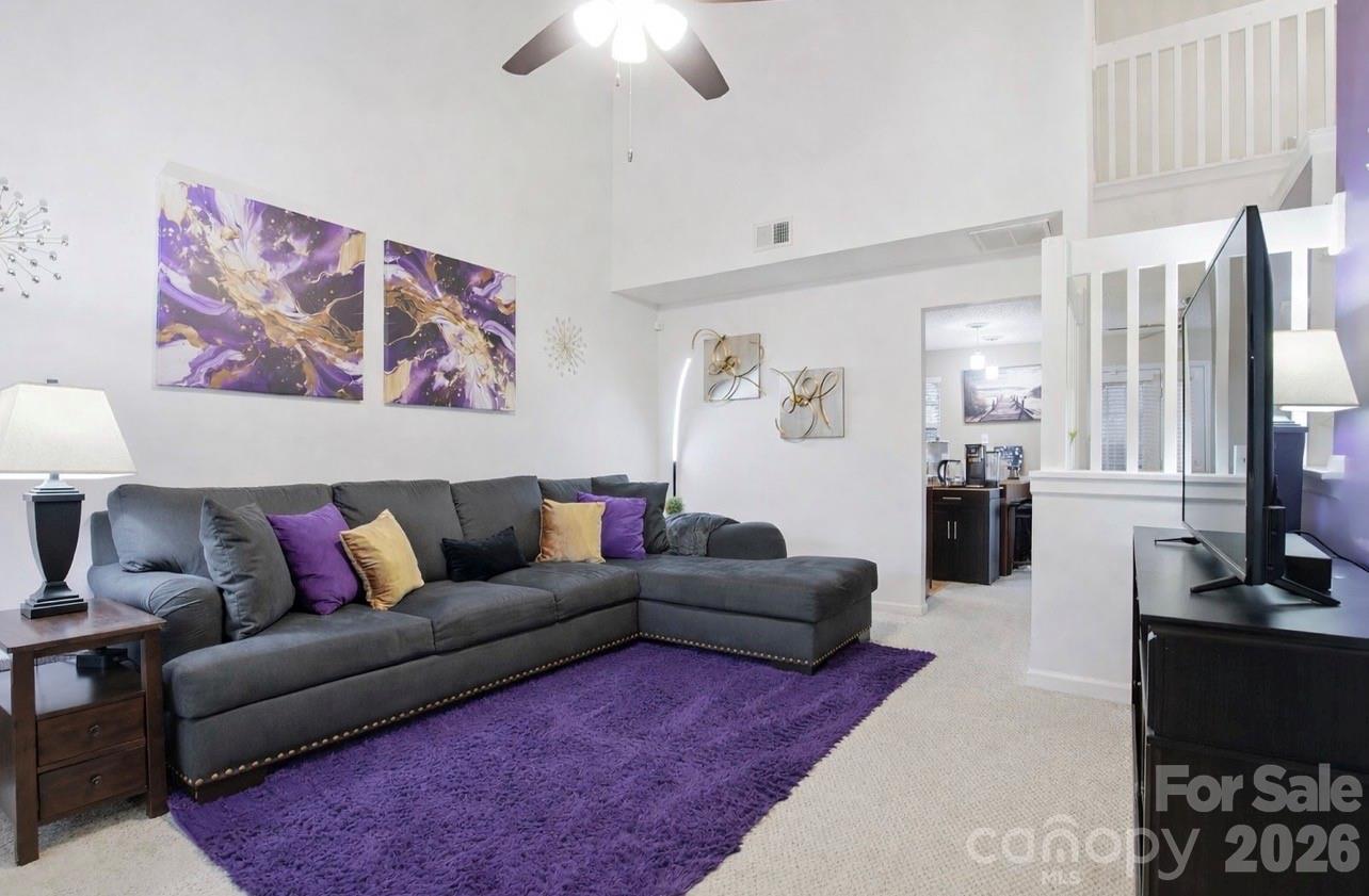 8376 Rudolph Road Charlotte, NC 28216 - Photo 9 of 28 a living room with furniture fireplace and a chandelier