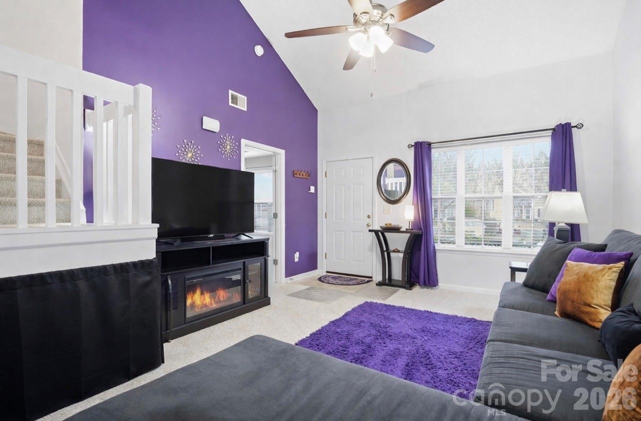 8376 Rudolph Road Charlotte, NC 28216 - Photo 10 of 28 a living room with furniture and a flat screen tv
