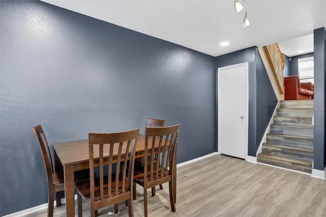 a view of a hallway with wooden floor and stairs