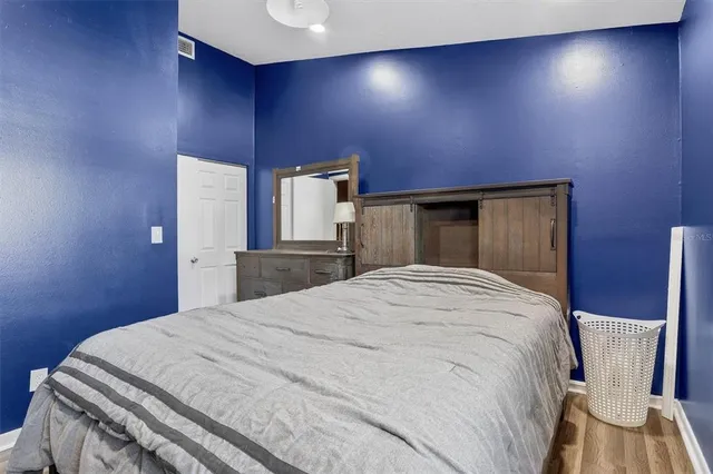 a bedroom with a bed and a chair