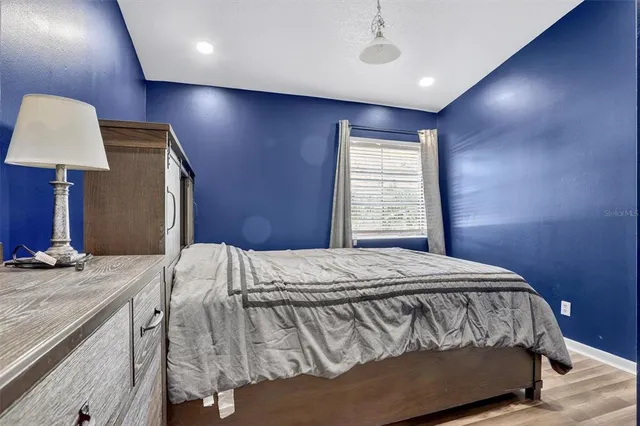 a bedroom with a bed and a lamp