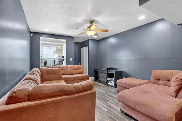 a living room with furniture and a chandelier