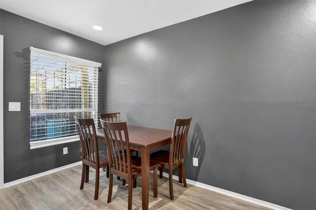 a view of a dining room with furniture and wooden floor