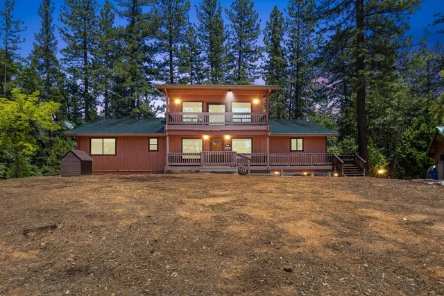 a view of a house with a yard and garage