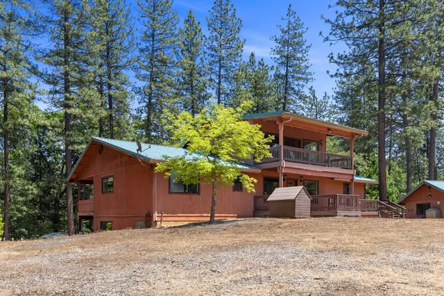a view of a livingroom with furniture wooden floor windows and a ceiling fan