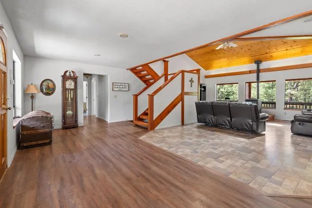 a view of a livingroom with furniture and a large window