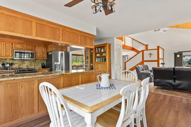 a living room with furniture a ceiling fan and a rug