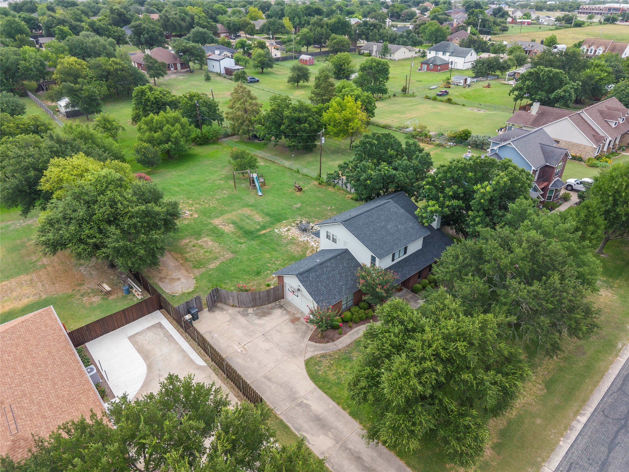 1329 Quail Ravine Round Rock, TX 78664 - Photo 18 of 39 Mature trees surround this home situated on an expansive green lot with a large driveway.