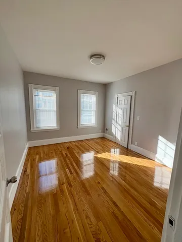 a spacious bedroom with a bed and a window
