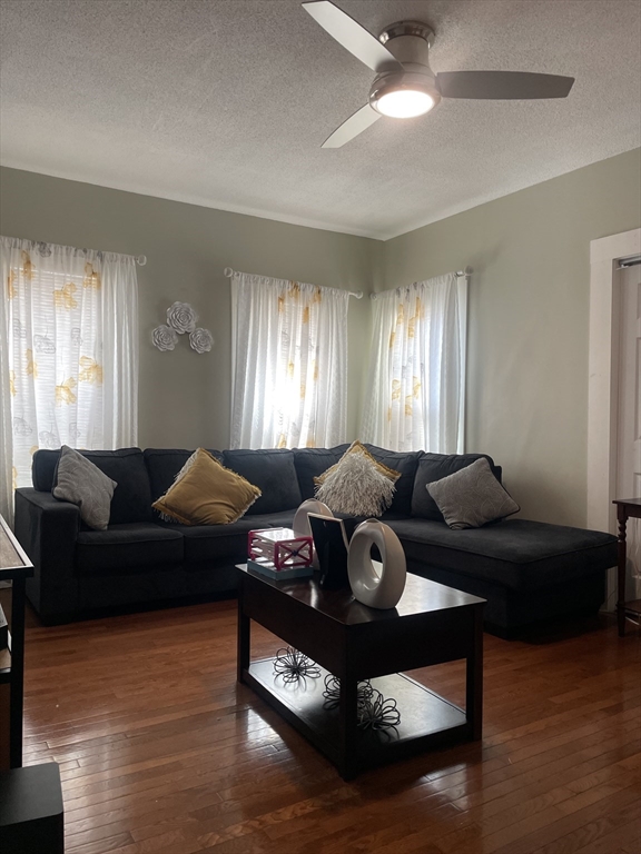 58 Brett Street, Unit 1 Brockton, MA 02301 - Photo 4 of 7 a living room with furniture and a wooden floor