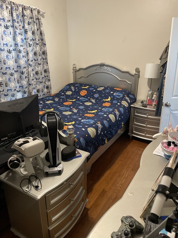 58 Brett Street, Unit 1 Brockton, MA 02301 - Photo 6 of 7 a bed sitting in a bedroom next to a window