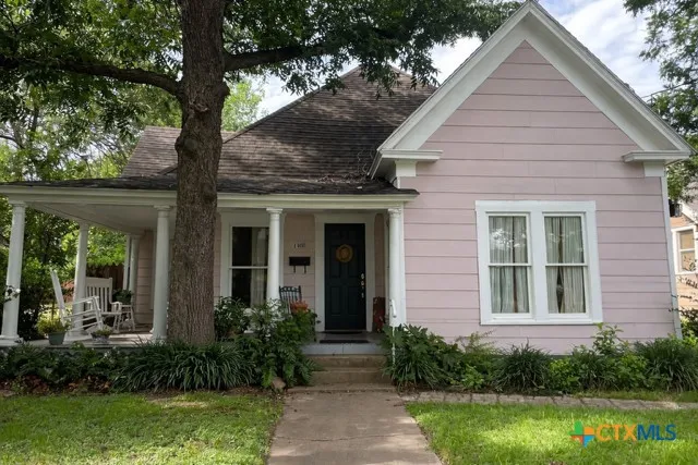 a front view of a house with garden