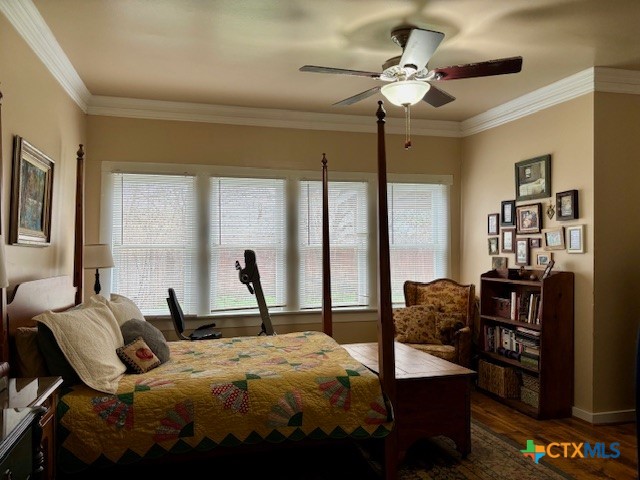 1408 Bridge Street Gatesville, TX 76528 - Photo 18 of 24 a bed room with a bed and a chandelier