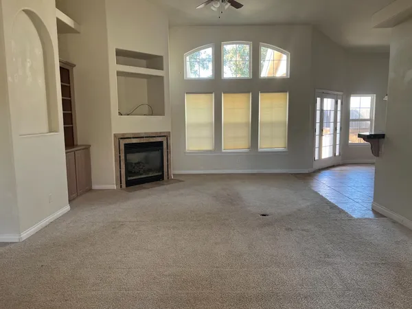 an empty room with furniture and a fireplace
