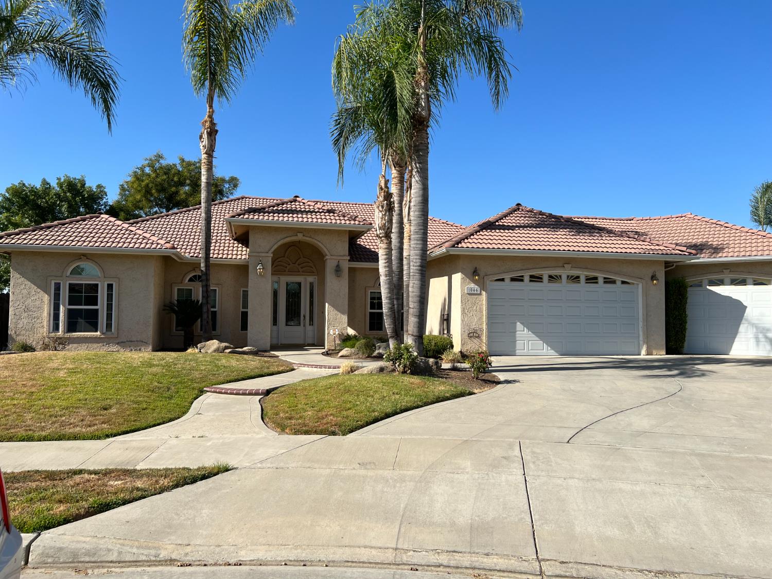 1046 Lords Court Lemoore, CA 93245 - Photo 1 of 23 a front view of a house with garden