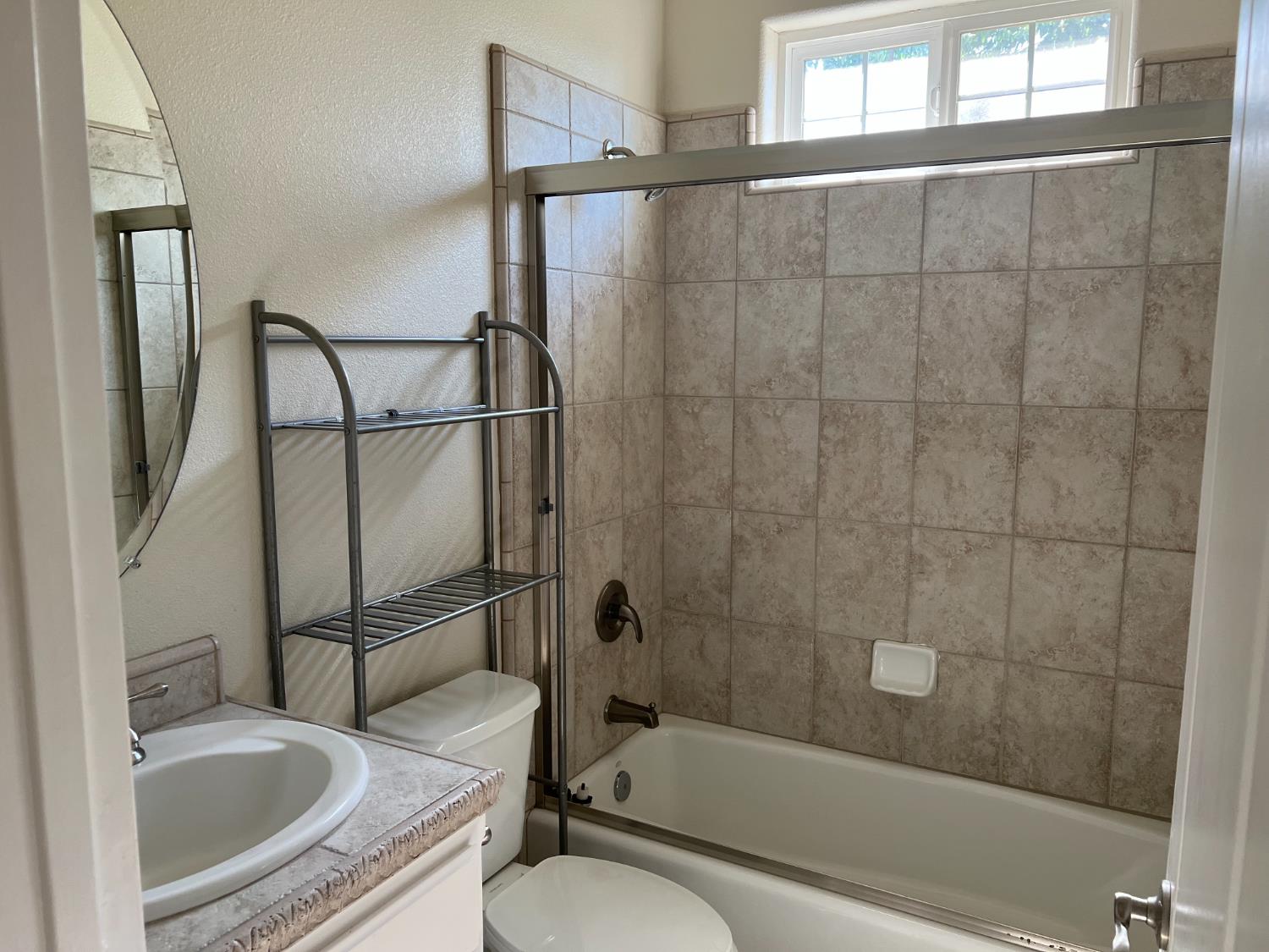 1046 Lords Court Lemoore, CA 93245 - Photo 11 of 23 a bathroom with a granite countertop bathtub shower sink vanity and toilet