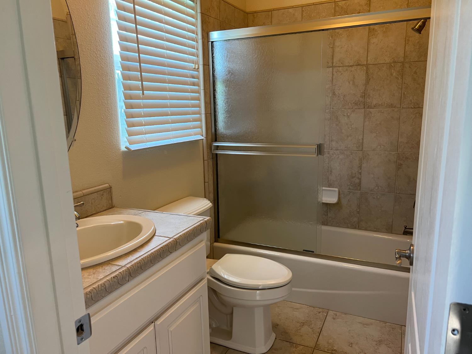1046 Lords Court Lemoore, CA 93245 - Photo 13 of 23 a bathroom with a sink a toilet and shower