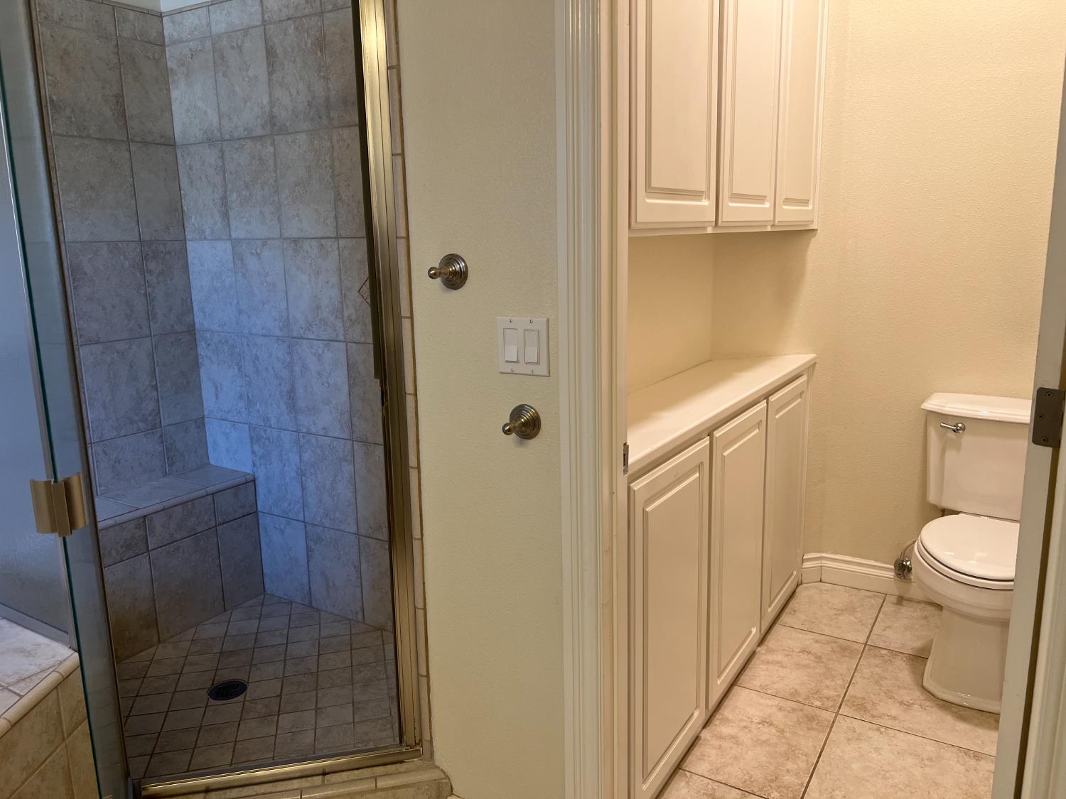 1046 Lords Court Lemoore, CA 93245 - Photo 19 of 23 a bathroom with a granite countertop shower and a toilet