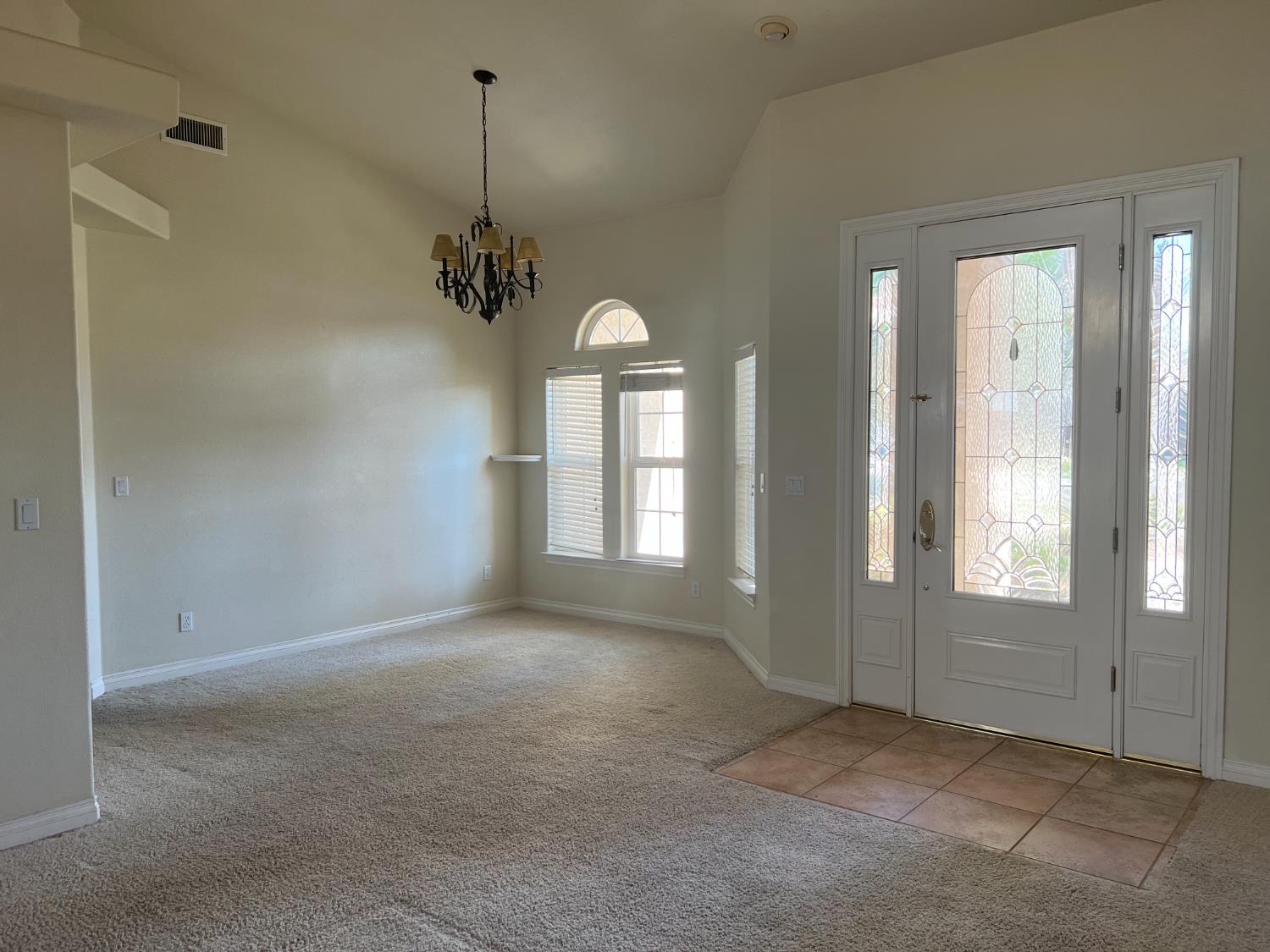 1046 Lords Court Lemoore, CA 93245 - Photo 6 of 23 en empty room with windows and ceiling fan