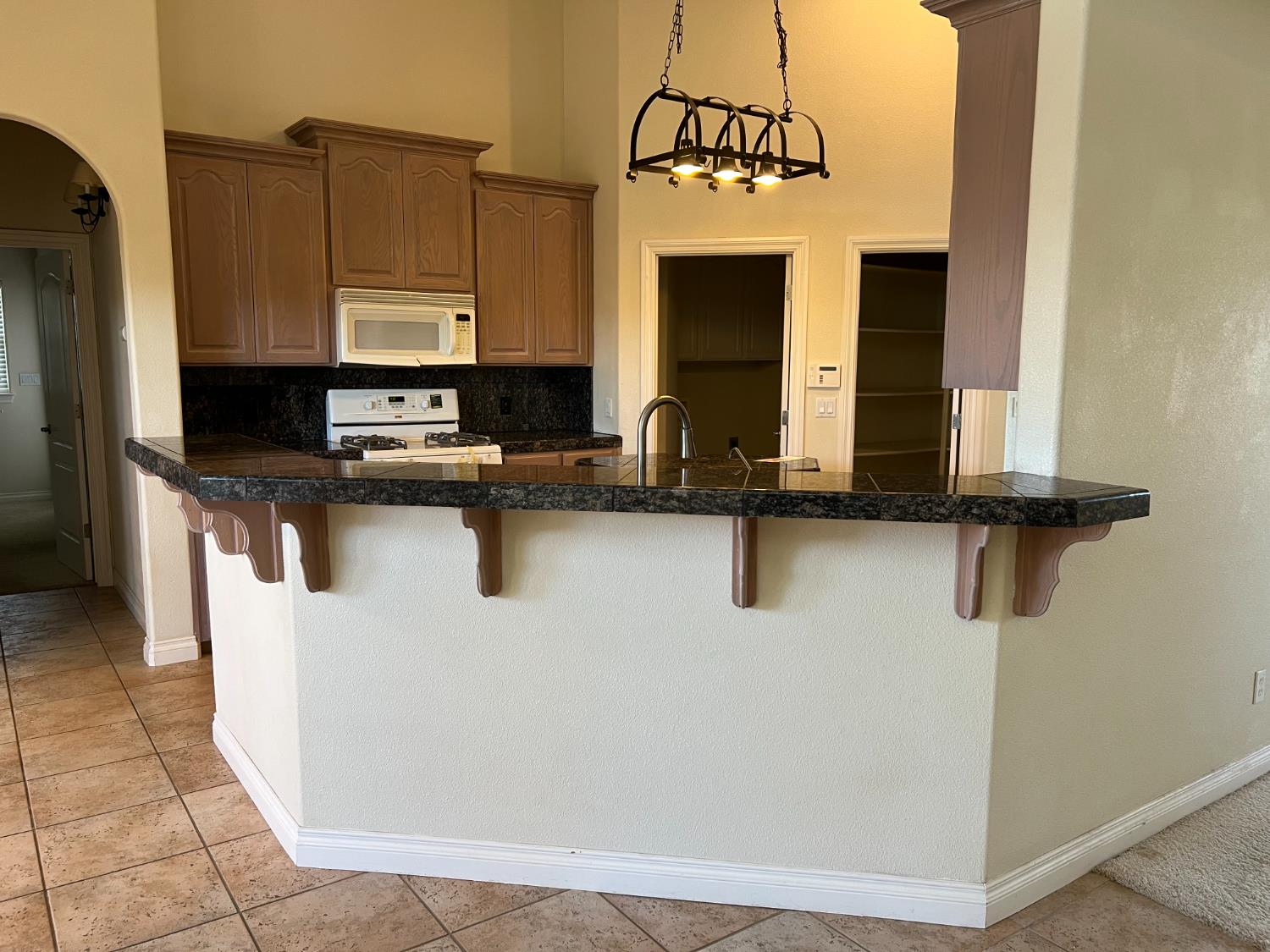 1046 Lords Court Lemoore, CA 93245 - Photo 7 of 23 a kitchen with stainless steel appliances granite countertop a sink a stove and refrigerator