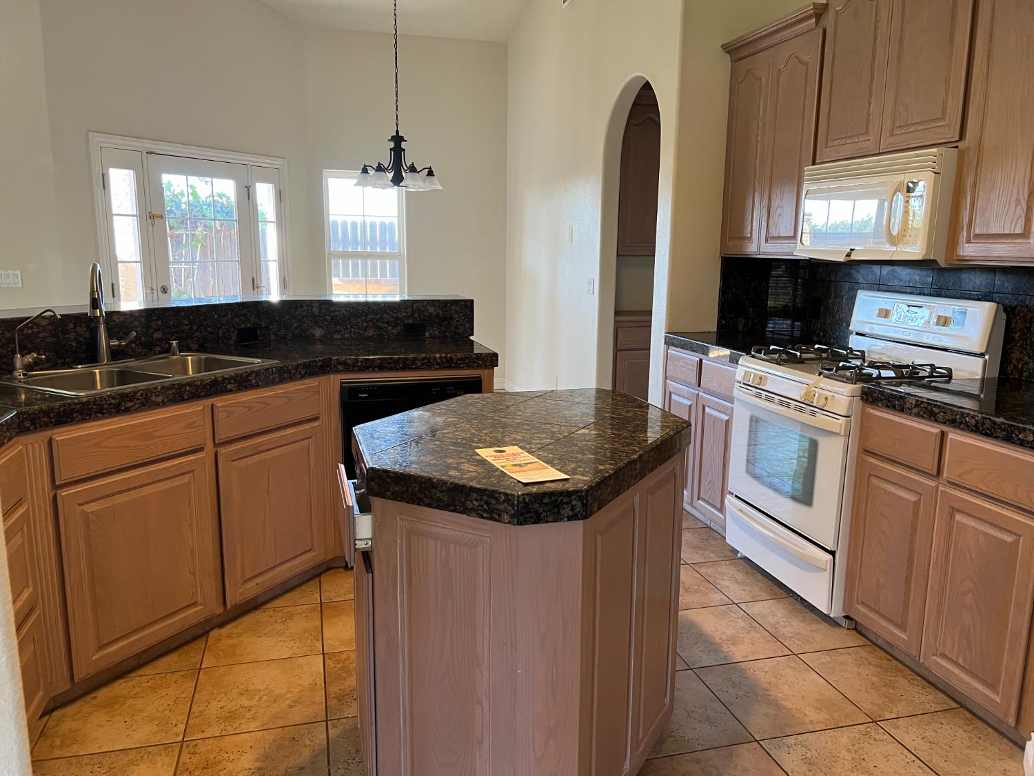 1046 Lords Court Lemoore, CA 93245 - Photo 9 of 23 a kitchen with stainless steel appliances granite countertop a stove a sink and a microwave