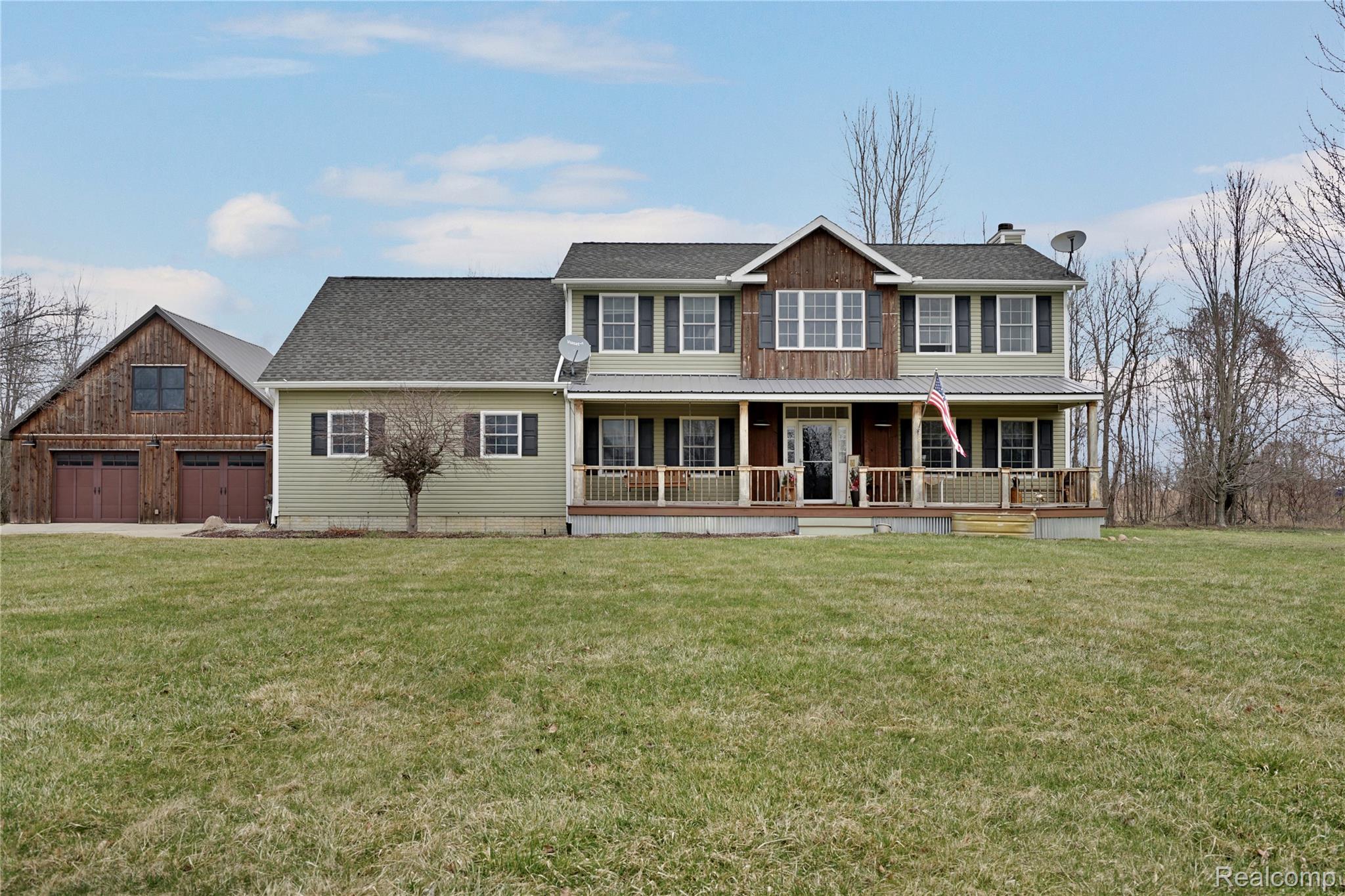 3690 Brauer Road Oxford, MI 48371 - Photo 1 of 63 View of front facade featuring a porch, a front lawn, a chimney, and a shingled roof