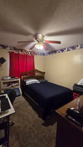 a bed room with a bed and a desk