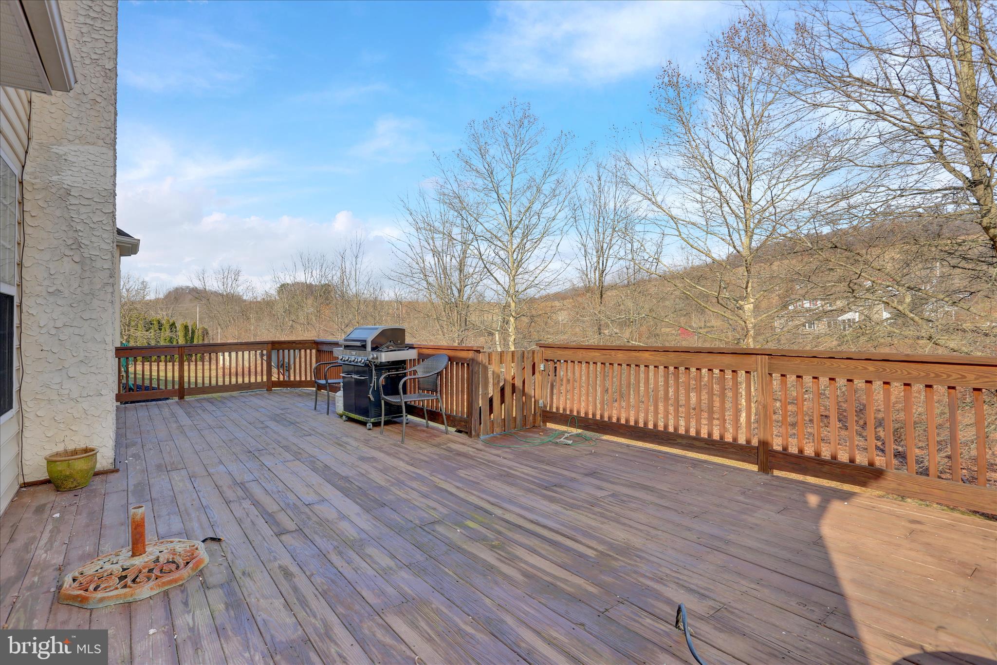 261 Sittler Valley Road Kutztown, PA 19530 - Photo 53 of 62 a view of a deck with wooden floor and barbeque grill with couches and table and chairs with wooden floor and fence